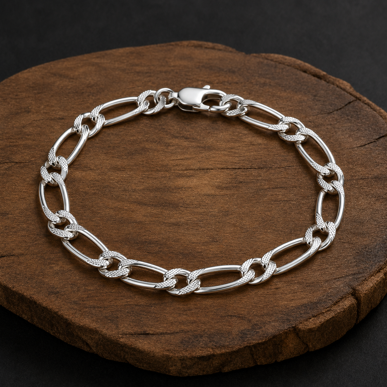 Close-up of Figaro links finished with a faceted face that catches light along the run on the Silvme faceted figaro chain bra