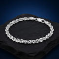 Full length of the twisted rope chain bracelet showing its polished silver-tone finish