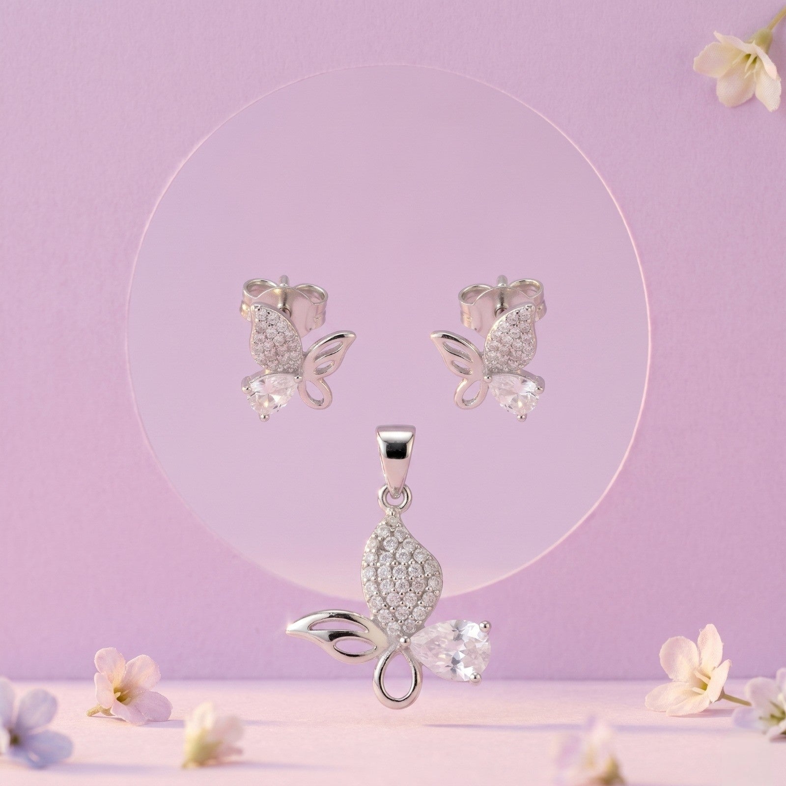 Pink Butterfly 925 sterling silver pendant and stud earrings jewellery set with pink cubic zirconia by Silvme â€” angled studio view