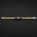 Full length of the black pave panel statement bracelet showing its black and gold-tone with silver finish