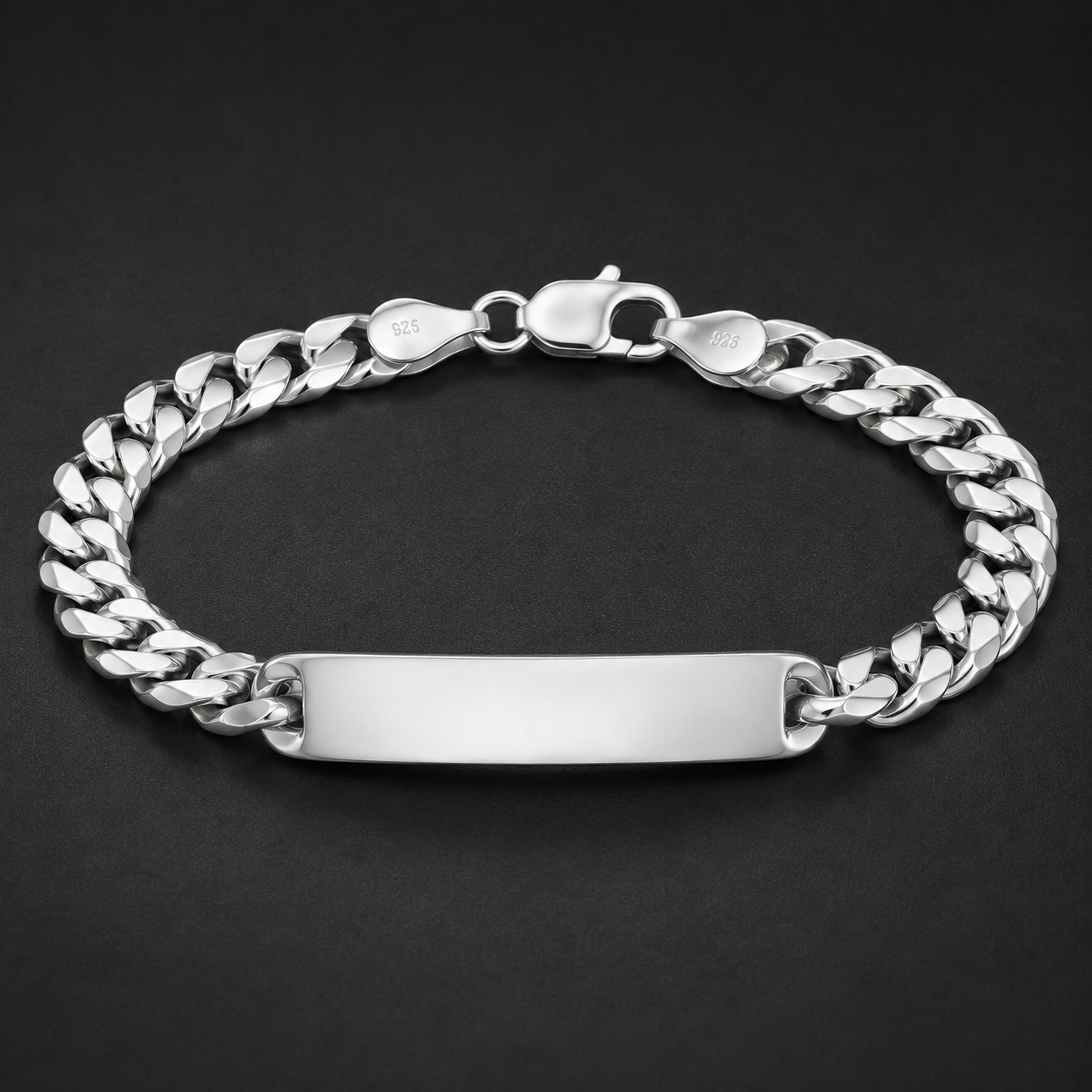 Full length of the curb chain id bracelet showing its polished silver-tone finish