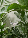 Geometric Pink 925 sterling silver pendant necklace and stud earrings jewellery set with pink cubic zirconia by Silvme â€” styled view