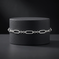 The oval and bead link bracelet for men shown against a plain studio background
