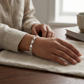 The wide curb chain bracelet for men shown against a plain studio background