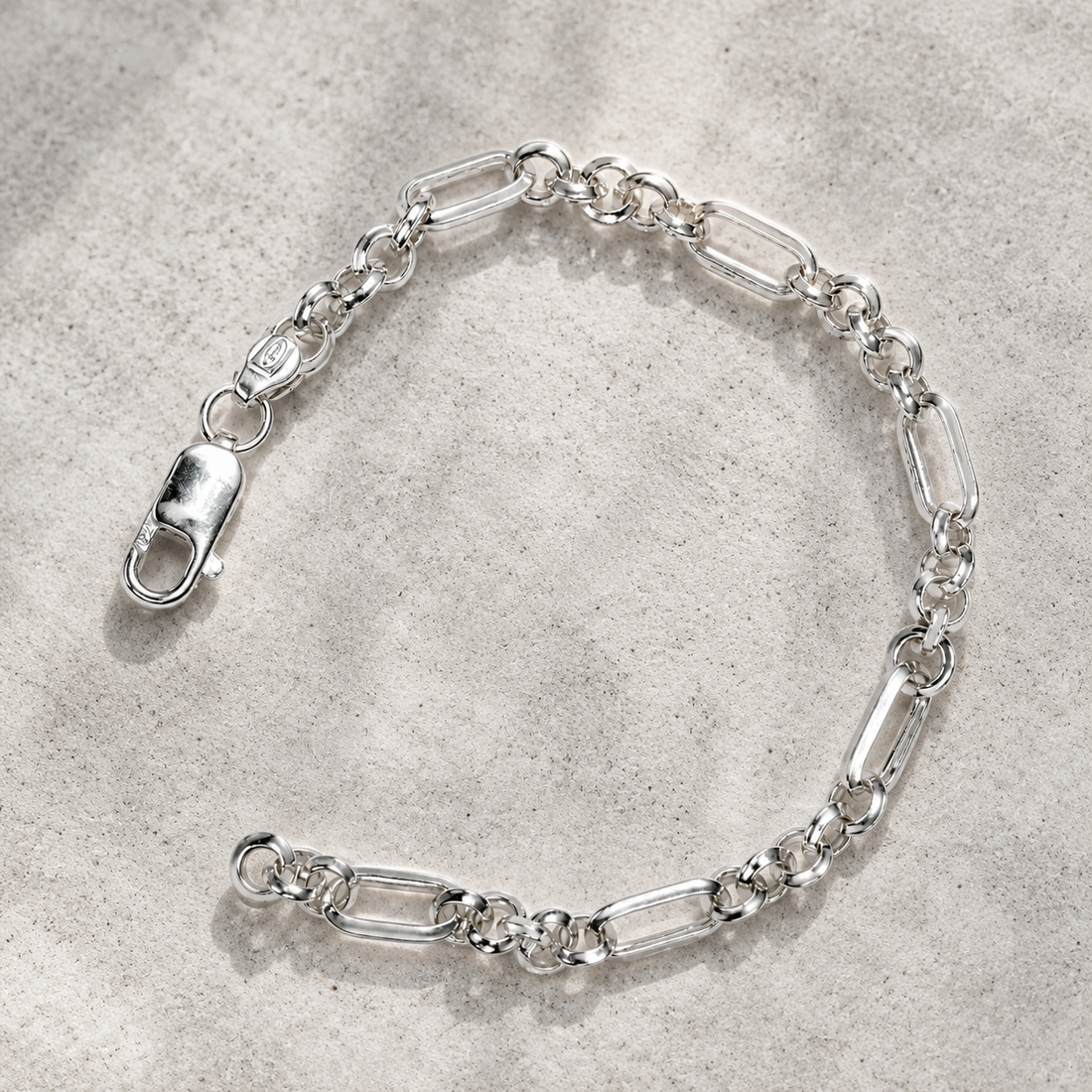 Silvme 925 sterling silver slim figaro chain bracelet for men shaped into an oval on a white background