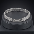 Full length of the slim textured link bracelet showing its polished silver-tone finish