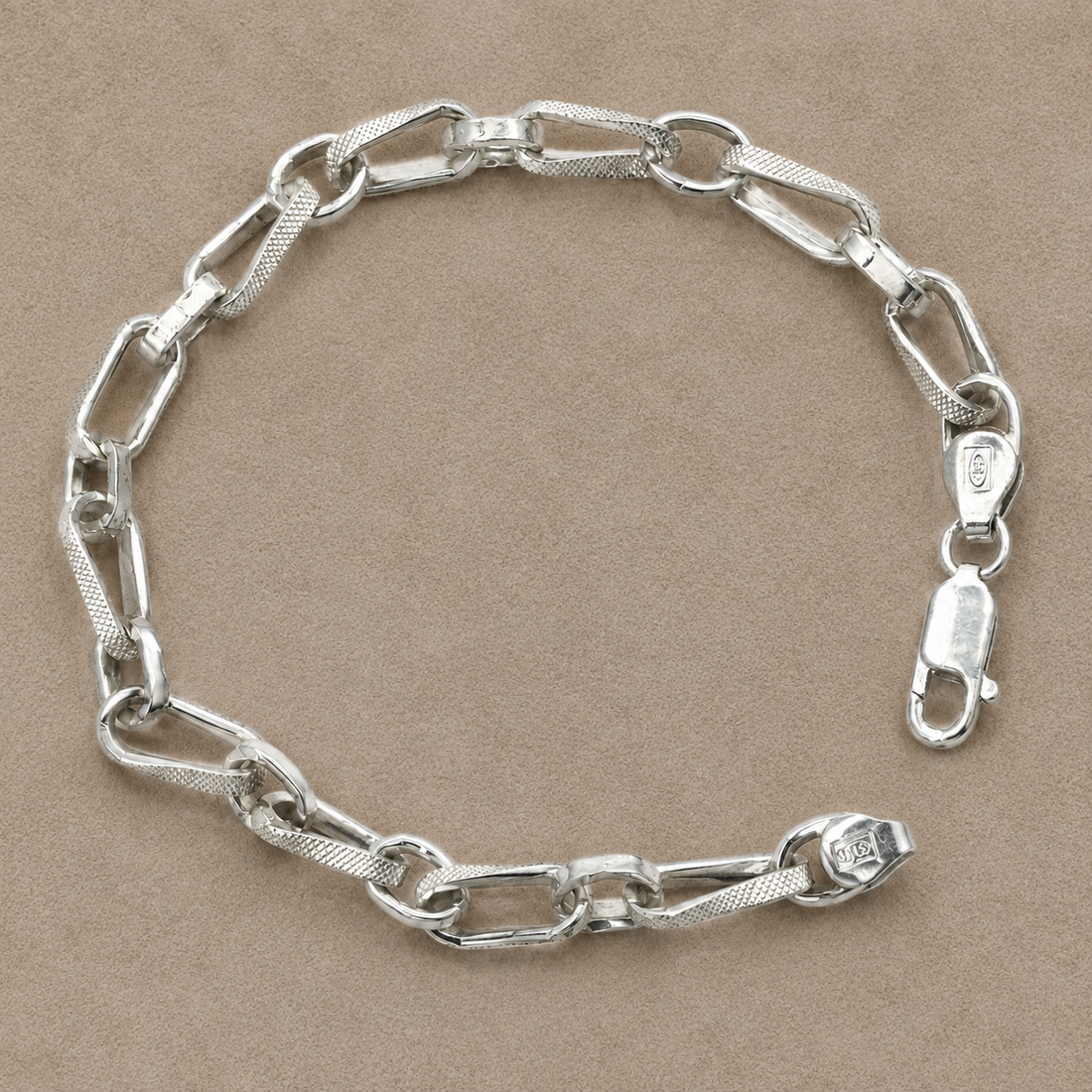 Silvme 925 sterling silver textured paperclip link bracelet for men shaped into an oval on a white background