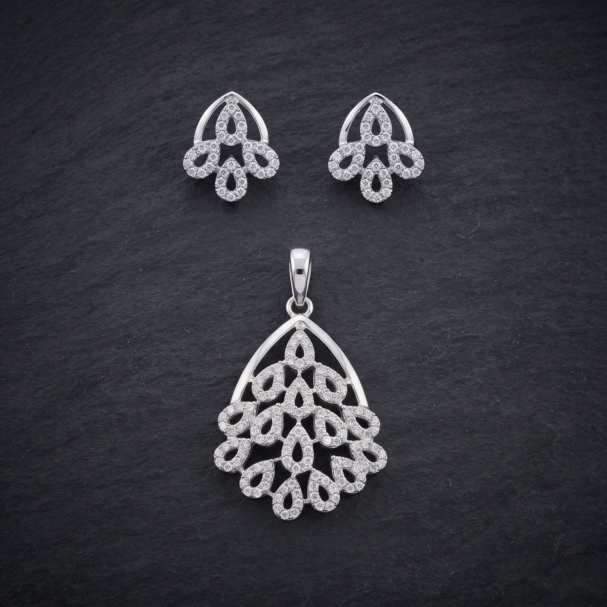 Silvme pure 925 sterling silver sparkling cubic zirconia pendant and stud earrings set with cubic zirconia, styled flatlay view