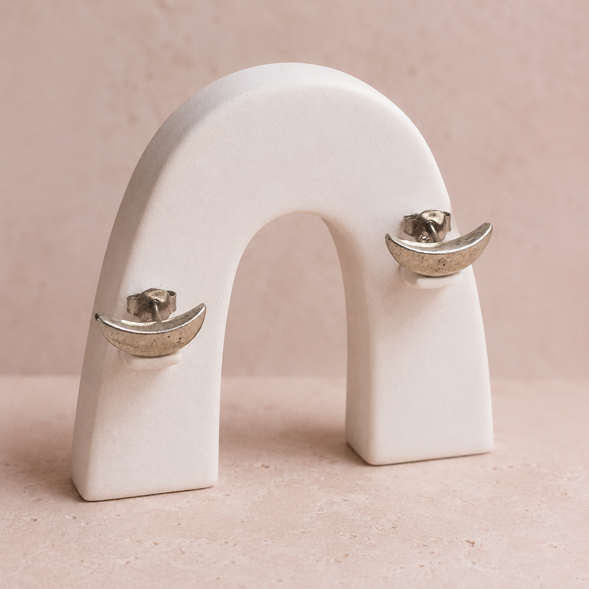 Crescent 925 silver stud earrings for women, office wear, styled flat lay