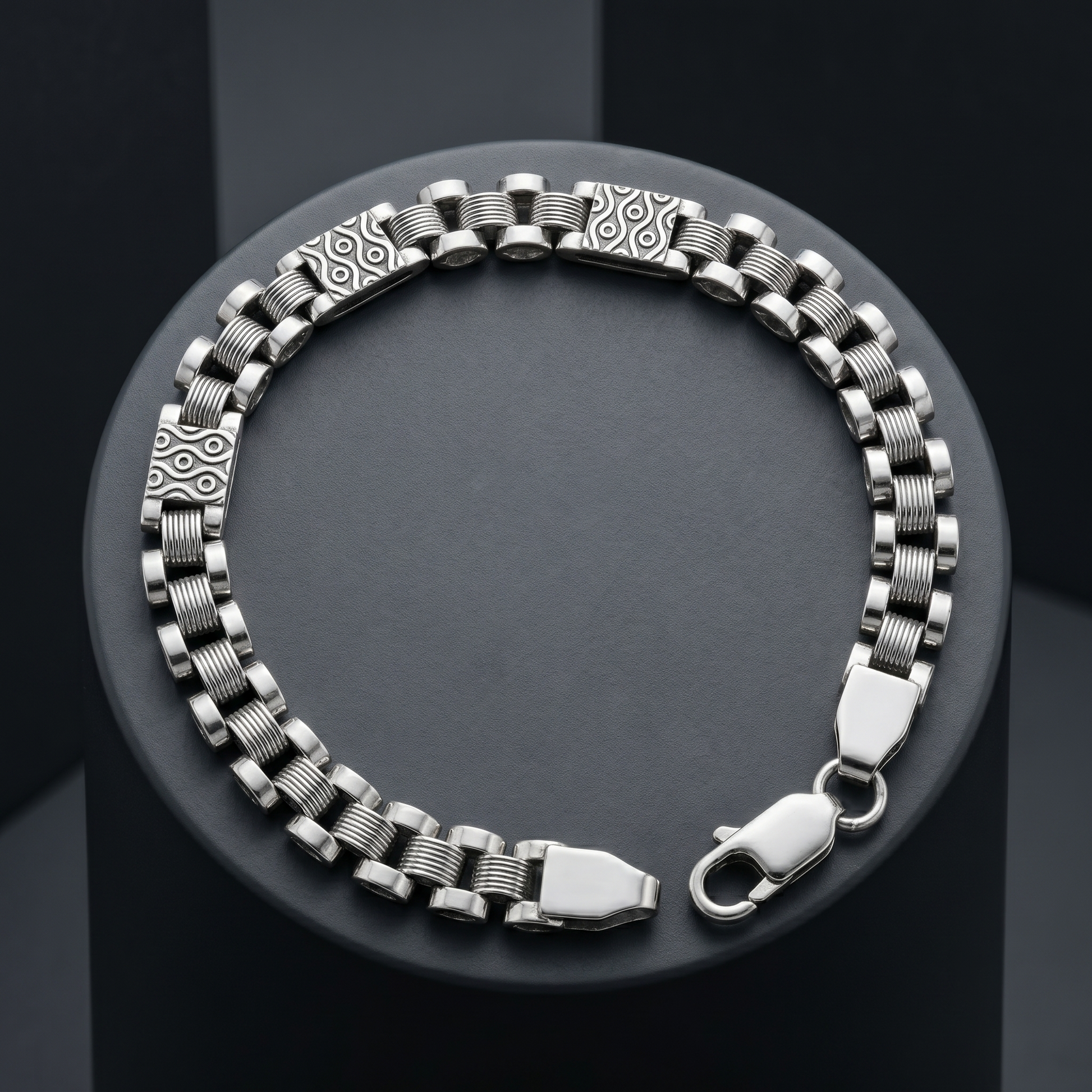 Full length of the engraved panel link bracelet showing its polished silver-tone finish
