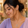 Interlocking crescent pendant worn at the neckline with a lilac outfit
