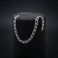 Full length of the curb chain bracelet showing its polished silver-tone finish