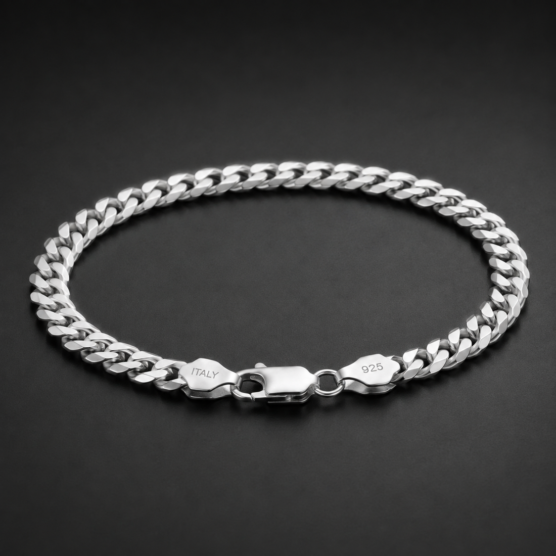 Full length of the heavy curb chain bracelet showing its polished silver-tone finish