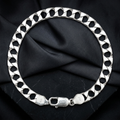 Close-up of a broad flat curb chain built for real presence on the wrist on the Silvme wide curb chain bracelet