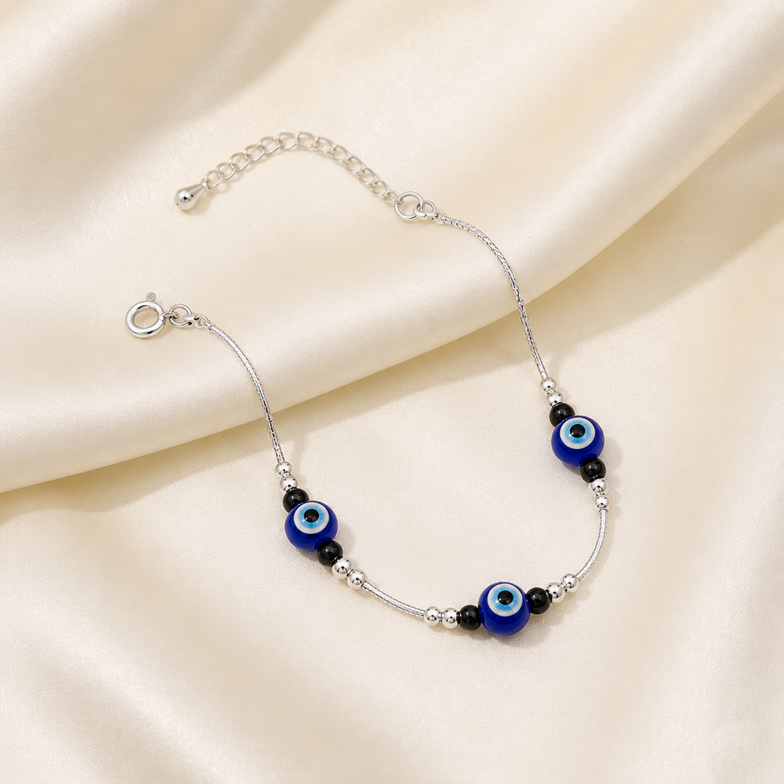 Silvme 925 sterling silver evil eye & black bead cluster anklet with a blue evil-eye and black-bead cluster, white background full view