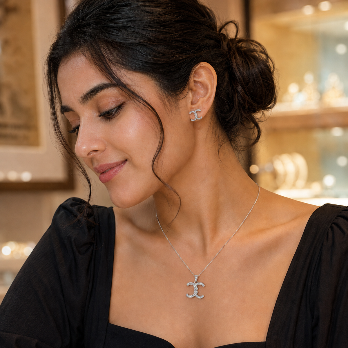 Interlocking crescent pendant and studs worn with a black outfit