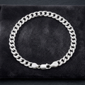 The polished curb chain bracelet for men shown against a plain studio background