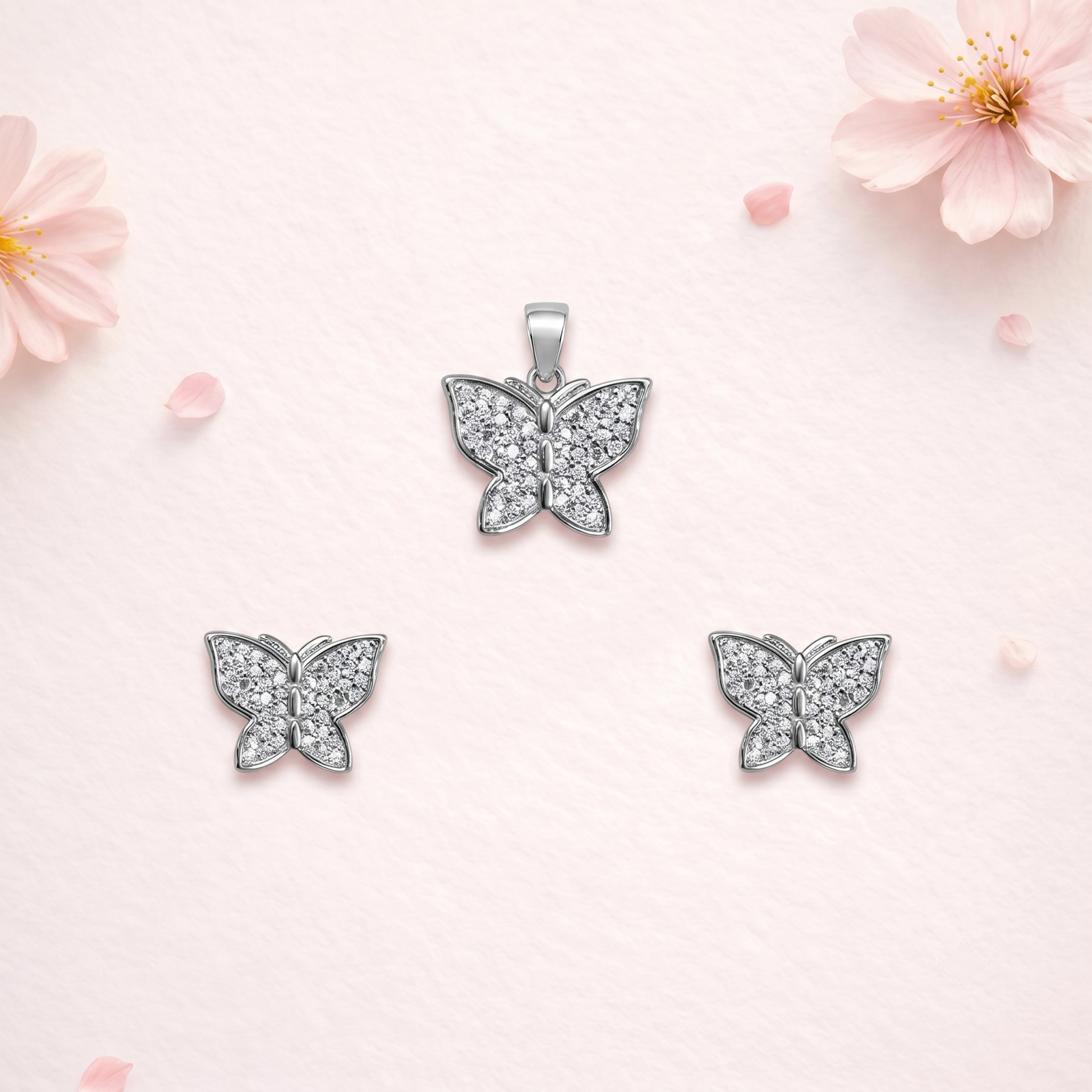 Butterfly 925 sterling silver pendant and stud earrings jewellery set with cubic zirconia by Silvme â€” angled studio view