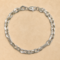 Close-up of mariner links interrupted by flat stations carrying a Greek key motif on the Silvme greek key mariner bracelet