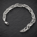 Close-up of broad links that fold over one another in a continuous twist on the Silvme interlocked twist link bracelet