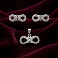 Infinity 925 sterling silver pendant and stud earrings jewellery set with cubic zirconia by Silvme â€” angled studio view