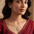 Cat face pendant worn at the neckline with a red festive outfit