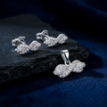 Twisted Infinity 925 sterling silver pendant and stud earrings jewellery set with cubic zirconia by Silvme â€” angled studio view
