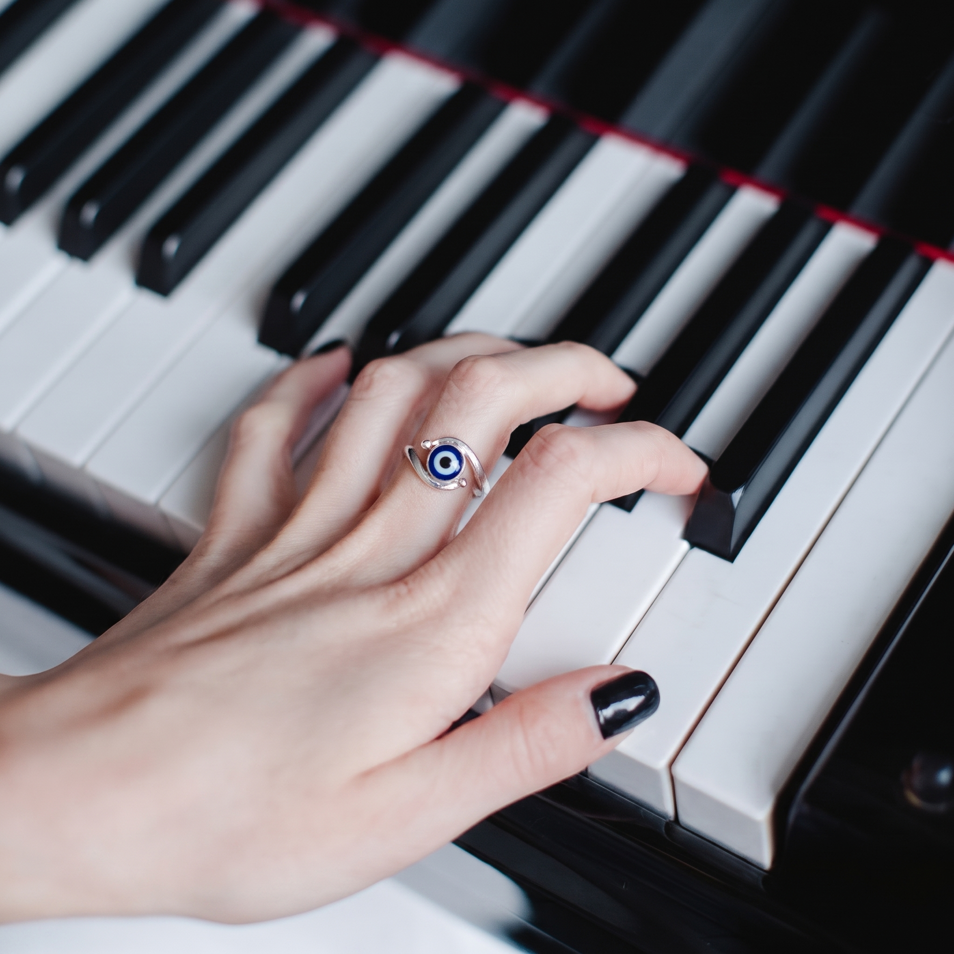 Close-up of the navy evil eye on a curved bypass band, Silvme 925 sterling silver evil eye bypass ring for women