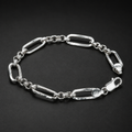 Close-up of long paperclip links separated by small round connectors on the Silvme paperclip and round link bracelet