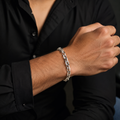 Full length of the interlocked twist link bracelet showing its polished silver-tone finish