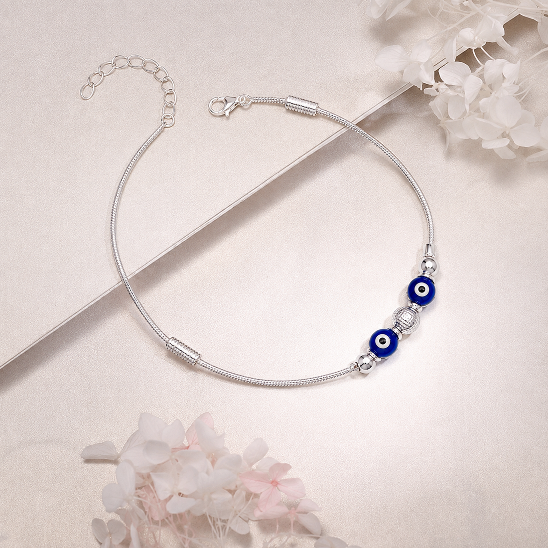 Silvme 925 sterling silver blue evil eye snake chain anklet with twin blue evil-eye beads on a snake chain, white background full view