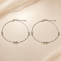 Close-up of polished silver beads and a small fan charm on the Silvme 925 sterling silver silver bead snake chain anklet