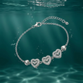 Triple Heart design detail on the Silvme Triple Heart Pavé Charm Bracelet, crafted in polished 925 silver