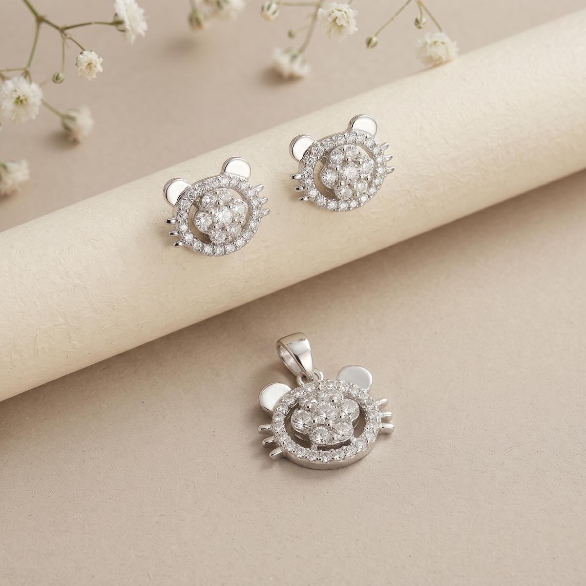 Cat face silver set styled on a neutral backdrop showing the ear and whisker detail