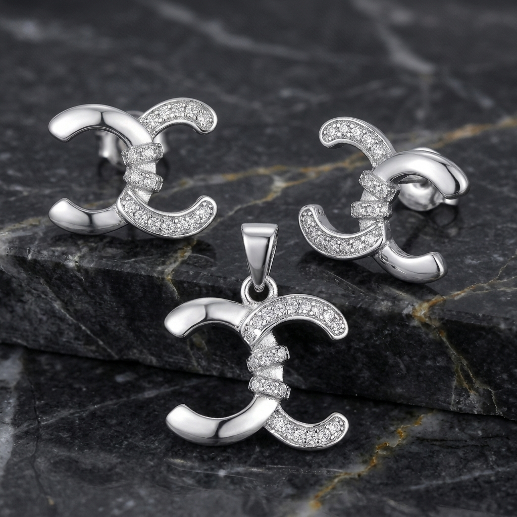 Interlocking crescent silver set arranged on a dark marble surface