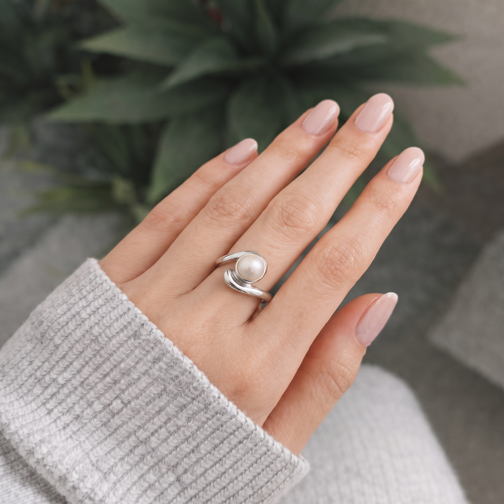 Close-up of the round pearl and a silver bead on a swirl band, Silvme 925 sterling silver pearl swirl bypass ring for women