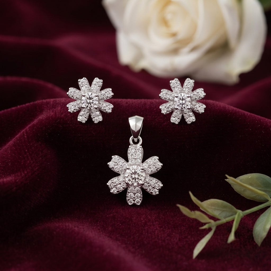 Silvme pure 925 sterling silver blossom flower pendant and stud earrings set with cubic zirconia, styled flatlay view