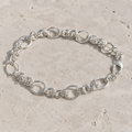 Full length of the textured rolo chain bracelet showing its polished silver-tone finish