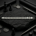 Full length of the floral medallion link bracelet showing its polished silver-tone finish