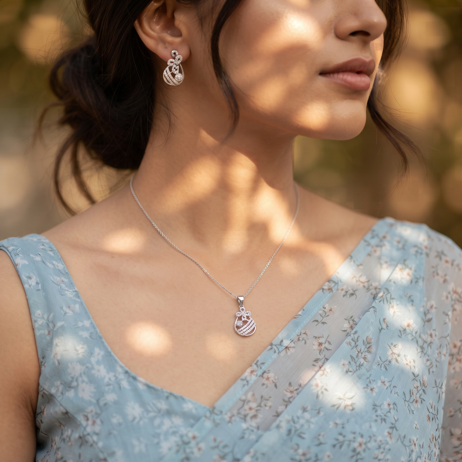Silvme pure 925 sterling silver floral drop pendant and drop earrings set with cubic zirconia, styled lifestyle image
