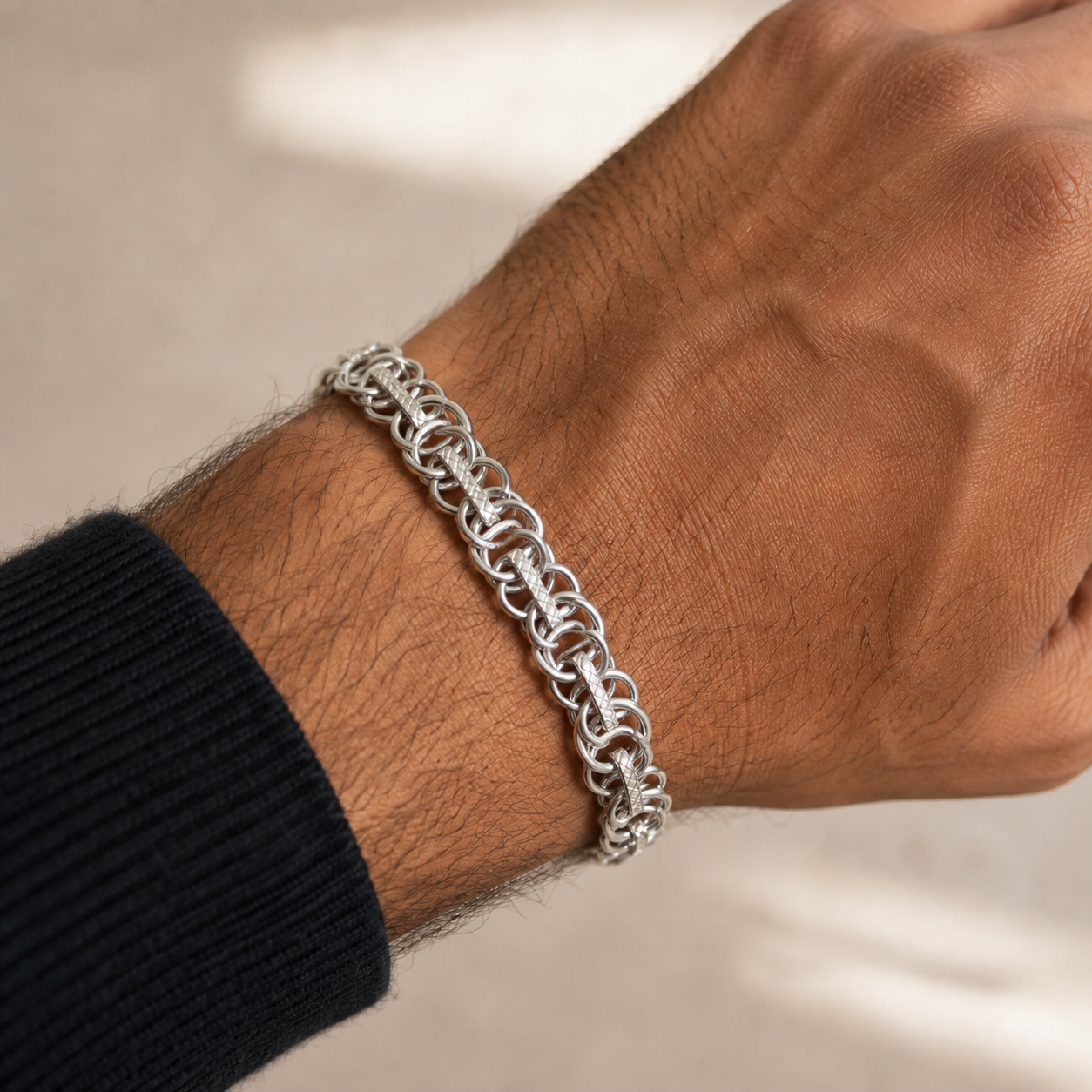 The fine rolo chain bracelet for men shown against a plain studio background