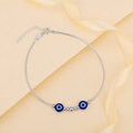 Charm, bead and chain detail on the Silvme twin blue evil eye 925 silver anklet payal