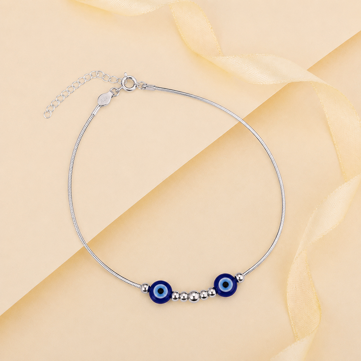 Charm, bead and chain detail on the Silvme twin blue evil eye 925 silver anklet payal