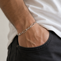 Full length of the paperclip and round link bracelet showing its polished silver-tone finish