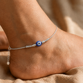 Close-up of a single blue evil-eye bead on the Silvme 925 sterling silver single evil eye anklet