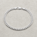 Full length of the heavy curb chain bracelet showing its polished silver-tone finish
