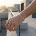 Full length of the two-tone bar link bracelet showing its two-tone silver and gold-tone finish