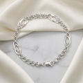 The oval station rolo bracelet for men shown against a plain studio background