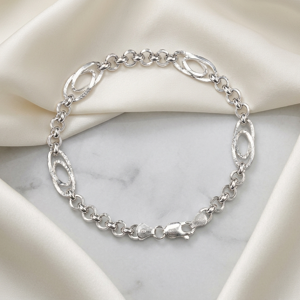 The oval station rolo bracelet for men shown against a plain studio background