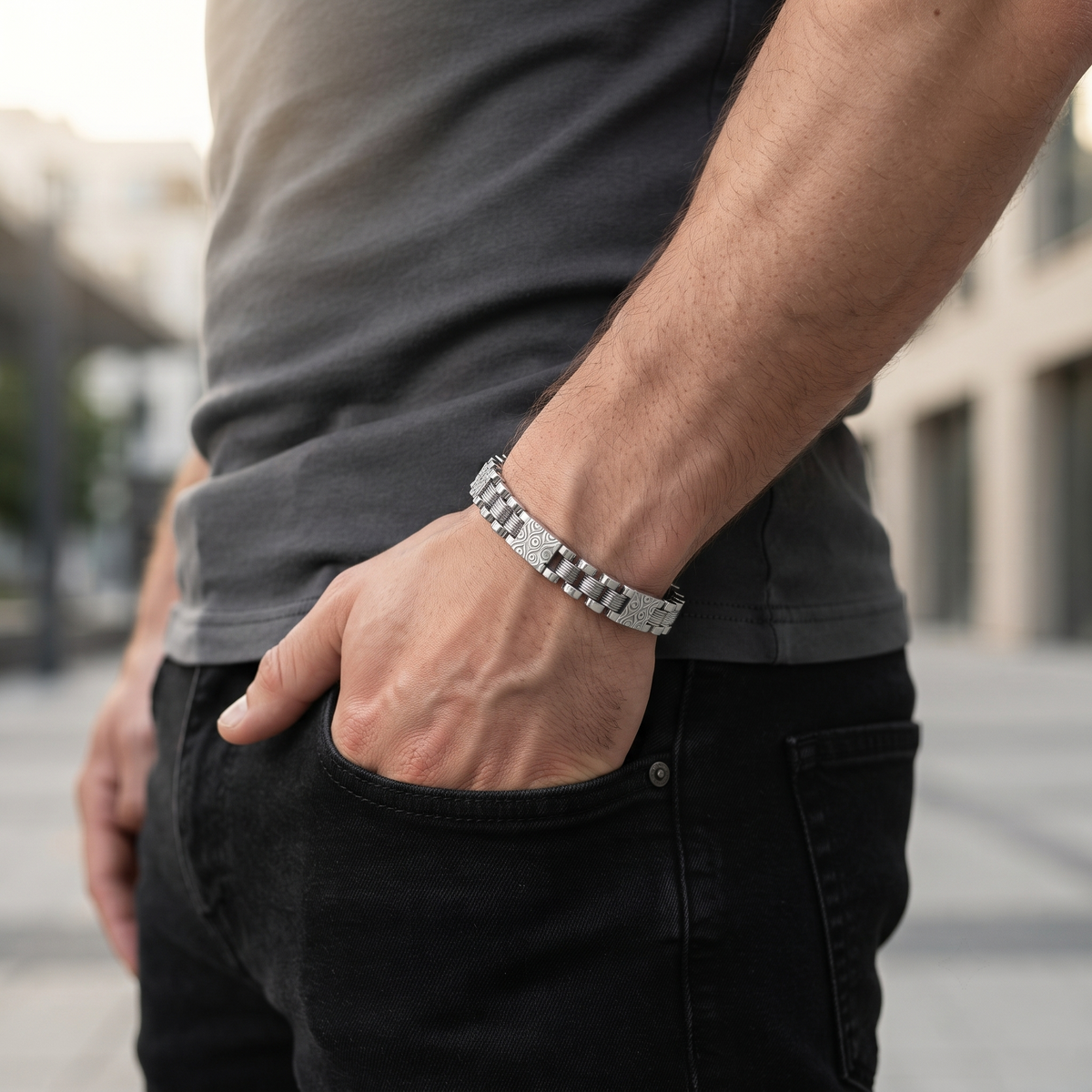 Close-up of wide links carried by a repeating engraved scroll pattern on the Silvme engraved panel link bracelet